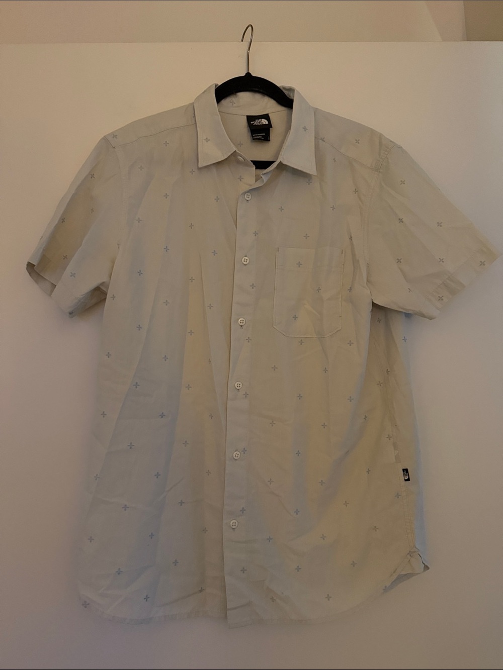 The North Face Light Beige Short-Sleeve Button-Up Shirt with Subtle Blue Print
